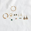 Assorted unique earrings for women displayed on a neutral fabric background