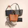 Three modern handbags on a neutral background with scarf and sunglasses