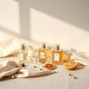 Elegant perfume bottles and scent sample vials arranged on a clean tabletop with warm lighting