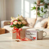 Colorfully wrapped gift with flowers and a card on a bright table for Mother’s Day