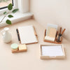 Neatly arranged planner, notepads, cards, and pens on a minimalist desk