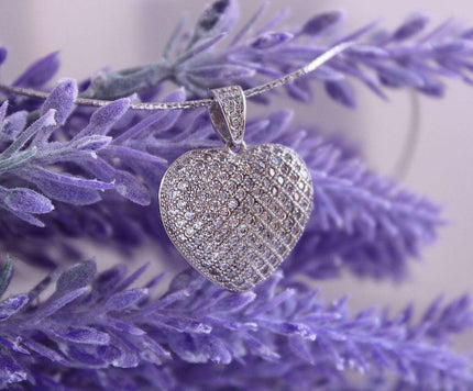 a silver ball on a purple chain